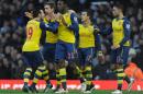 Arsenal's Danny Welbeck, center, celebrates with teammates after scoring against West Ham during their English Premier League soccer match at Upton Park, London, Sunday, Dec. 28, 2014. (AP Photo/Daniel Hambury, PA Wire) UNITED KINGDOM OUT - NO SALES - NO ARCHIVES