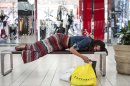 Jasmine Britton of Huntington Beach rests while shopping at the Los Cerreitos Center mall on Black Friday in Cerritos