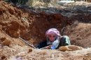 This citizen journalism image provided by Edlib News Network, ENN, which has been authenticated based on its contents and other AP reporting, shows an elderly Syrian rebel sit in a trench, in Idlib province, northern Syria, Wednesday, June 12, 2013. Syrian rebels have attacked a village in the country's east, killing dozens of Shiites, mostly pro-government fighters, activists said Wednesday. A Syrian government official denounced the attack, saying it was a "massacre" of civilians. (AP Photo/Edlib News Network ENN)