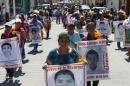 Relatives of the 43 missing students of the Ayotzinapa teacher training college march before receiving the final report on the disappearance of their sons by members of the Inter-American Commission on Human Rights in Tixtla