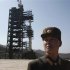 File photo of a soldier in front of a rocket sitting on a launch pad at the West Sea Satellite Launch Site, northwest of Pyongyang