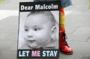 A banner calling for Australian Prime Minister Malcolm Turnbull to allow the infant children of asylum seekers to remain in Australia is shown during a demonstration in Melbourne