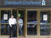 Employees of Standard Chartered leave a branch of the bank in central Seoul