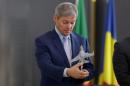 Romania's Prime Minister Dacian Ciolos looks at a scale model of a F-16 Fighting Falcon airplane at 86th Air Base of Romanian Air Force during the official presentation ceremony of 6 F-16 planes bought by the Romanian government, in Fetesti