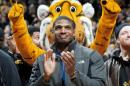 FILE - In this Feb. 15, 2014, file photo, Missouri's All-American defensive end Michael Sam claps during the Cotton Bowl trophy presentation at halftime of an NCAA college basketball game between Missouri and Tennessee in Columbia, Mo. Sam was selected in the seventh round, 249th overall, by the St. Louis Rams in the NFL draft Saturday, May 10, 2014. The Southeastern Conference defensive player of the year last season for Missouri came out as gay in media interviews this year. (AP Photo/L.G. Patterson, File)