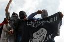 Kashmiri demonstrators hold up a flag of the Islamic State of Iraq and the Levant in downtown Srinagar, India on July 18, 2014