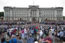 File picture shows crowds outside Buckingham Palace in central London watching as guardsmen take part in the Changing of the Guard ceremony on July 23, 2013