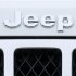 Logo on the front of a Jeep vehicle is shown at Chrysler dealership in Carlsbad, California