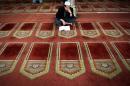 An Egyptian man reads from the Koran inside Al-Azhar mosque in the old city of Cairo on December 20, 2014