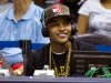 Rapper T.I. sits at the broadcast table as he helps call the action in the first half of an NBA basketball game between Miami Heat and Atlanta Hawks in Atlanta, Friday, Nov. 9, 2012. (AP Photo/John Bazemore)