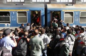 Migrants storm into a train at the Keleti train station &hellip;