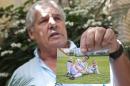 Osmar Machado, father of Chapecoense soccer player Filipe Machado who died in a plane crash while on his way to a game in Colombia, holds a photograph of his son and granddaughter Antonella during a interview in Chapeco, Brazil, Thursday, Dec. 1, 2016. His son died on his father's 66th birthday. (AP Photo/Andre Penner)