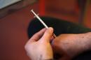 A heroin addict injects a heroin shot in a room, at the Konsumraume (consumption room) on November 5, 2012 in Berlin