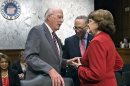 FILE - In this May 20, 2013 file photo, Senate Judiciary Committee Chairman Patrick Leahy, D-Vt., left, confers with Sen. Chuck Schumer, D-N.Y., center, and Sen. Dianne Feinstein, D-Calif., as the Senate Judiciary Committee assembled to work on a landmark immigration bill to secure the border and offer citizenship to millions, on Capitol Hill in Washington. Leading senators working on immigration legislation reached a compromise Tuesday on the details of an expanded high-tech visa program, officials said as the Senate Judiciary Committee neared completion of its work on the measure. At the same time, several officials said the White House has made it known to Leahy that it would prefer postponing a showdown over the rights of same sex spouses until a vote in the full Senate. (AP Photo/J. Scott Applewhite, File)