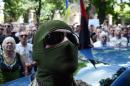 A masked man, soldier of the volunteer Ukrainian army "Donbass" battalion, takes part in a rally by Maidan activists at Independence Square in Kiev, calling upon the Ukrainian President to abandon the cease-fire, on June 29, 2014