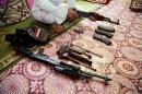 An Iraq weapon dealer cleans his weapon at his home in Baghdad, Iraq, Saturday, July 12, 2014. The weapon dealer said prices of weapons and ammunition have nearly doubled in recent weeks in Iraq. (AP Photo/Karim Kadim)