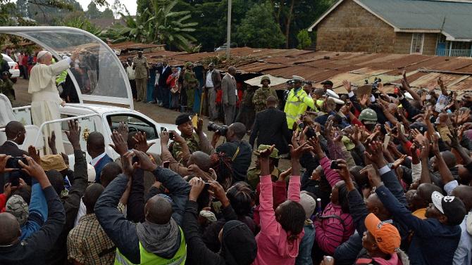 Wild singing and ululating erupted as Pope Francis&#39; arrived in Kangemi, his popemobile weaving through a sea of tin-roofed homes