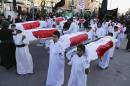 Shiite Muslim worshippers carry symbolic coffins for victims of the Islamic State