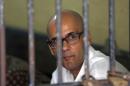 Canadian teacher Neil Bantleman sits inside a holding cell prior to the start of his trial hearing to listen to the prosecutor's demand at South Jakarta District Court in Jakarta, Indonesia, Thursday, March 12, 2015. Bantleman and Indonesia teaching assistant Ferdinant Tjiong were on trial on accusation of sexually abusing a kindergartner on the campus of a prestigious international school in the capital. (AP Photo/Dita Alangkara)