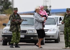 A woman and a baby cross the border from Ukraine to&nbsp;&hellip;