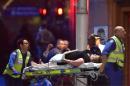 An injured hostage is carried out of a cafe in the central business district of Sydney, on December 16, 2014