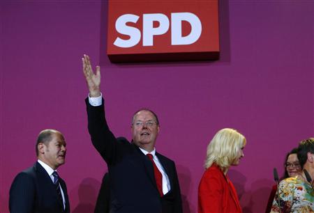 Hamburg Mayor Scholz, Steinbrueck, top candidate of the SPD in the German general election Bundestagswahl and party member Schwesig leave the party headquarters after first exit polls in Berlin