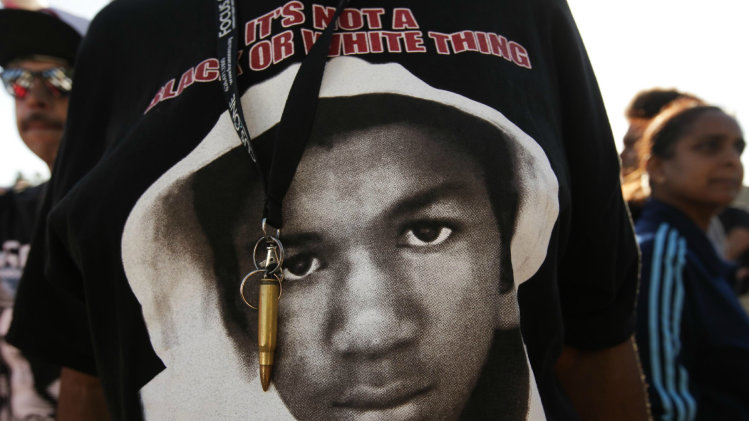 An image of Trayvon Martin and a bullet shell keychain hang from a protester&#39;s lanyard in Los Angeles, July 15, 2013. (Jae C. Hong/AP)