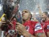 Australia's Queensland Reds Genia celebrates with the trophy after winning the Super rugby final against New Zealand's Canterbury Crusaders in Brisbane