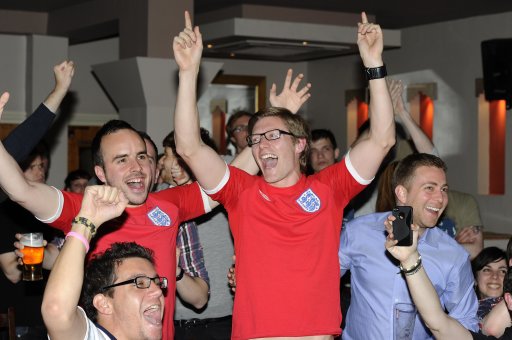 England fans react at end of England's Euro 2012 soccer match against Ukraine at a pub in London
