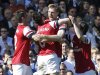 Arsenal players celebrate with their teammate Per Mertesacker, 2nd right, after he scored against Fulham during their English Premier League soccer match at the Craven Cottage ground in London, Saturday, April 20, 2013. Arsenal won the match 1-0.(AP Photo/Lefteris Pitarakis)