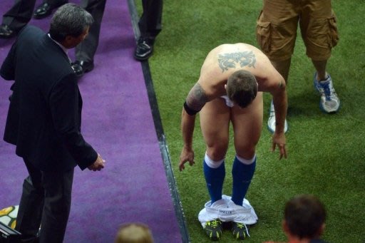 Italian forward Antonio Cassano takes off his shorts to give to a fan