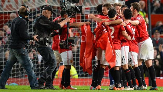 Manchester United players celebrate after beating Aston Villa 3-0 and winning the Premiership title following the English Premier League football match between Manchester United and Aston Villa at Old Trafford in Manchester (AFP)