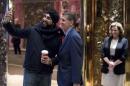 K.T. McFarland, Deputy National Security Adviser for President-elect Donald Trump, right, watches as Michael Flynn, President-elect Donald Trump's nominee for National Security adviser, center, takes a selfie with Sukhwinder Sangha of Vancouver, Canada, left, at Trump Tower, Monday, Dec. 5, 2016, in New York. (AP Photo/Andrew Harnik)