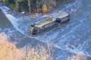 This image provided by KAKE-TV shows a school bus after it toppled into a creek, Thursday, Oct. 31, 2013 in Douglass, Kan. Ten Kansas children and a school bus driver were pulled to safety from a fast-moving creek Thursday after the bus toppled into the water and landed half-submerged on its side. (AP Photo/KAKE-TV) MANDATORY CREDIT; THE WICHITA EAGLE OUT
