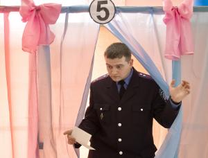 An Ukrainian policeman exits a voting booth after casting&nbsp;&hellip;