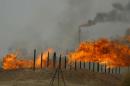 Flared gas burns at the Kirkuk oil field on June 29, 2009