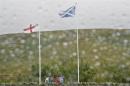 Scottish and English flags flutter in the wind and rain at the border between England and Scotland at Carter Bar