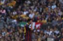Barcelona's Lionel Messi from Argentina puts his hand on his mouth during a Spanish La Liga soccer match between FC Barcelona and Atletico Madrid at the Camp Nou stadium in Barcelona, Spain, Saturday, May 17, 2014. (AP Photo/Andres Kudacki)