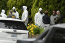 During the execution of a search warrant, members of the Joint Federal Haz-Mat Team, FBI, and local law enforcement gather in front of the Osmun Apartments near the intersection of First Avenue and Oak Street in Browne's Addition on Saturday, May 18, 2013 in Spokane, Wash. The search warrant is in connection with ricin-laced letters intercepted at a Post Office facility in Spokane earlier in the week. (AP Photo/TheSpokesman-Review, Colin Mulvany) COEUR D'ALENE PRESS OUT