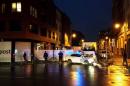 A photo taken on November 14, 2015 with a mobile phone shows Belgian police blocking a street during a police raid possibly in connection with the attacks in Paris, in Brussels' Molenbeek district