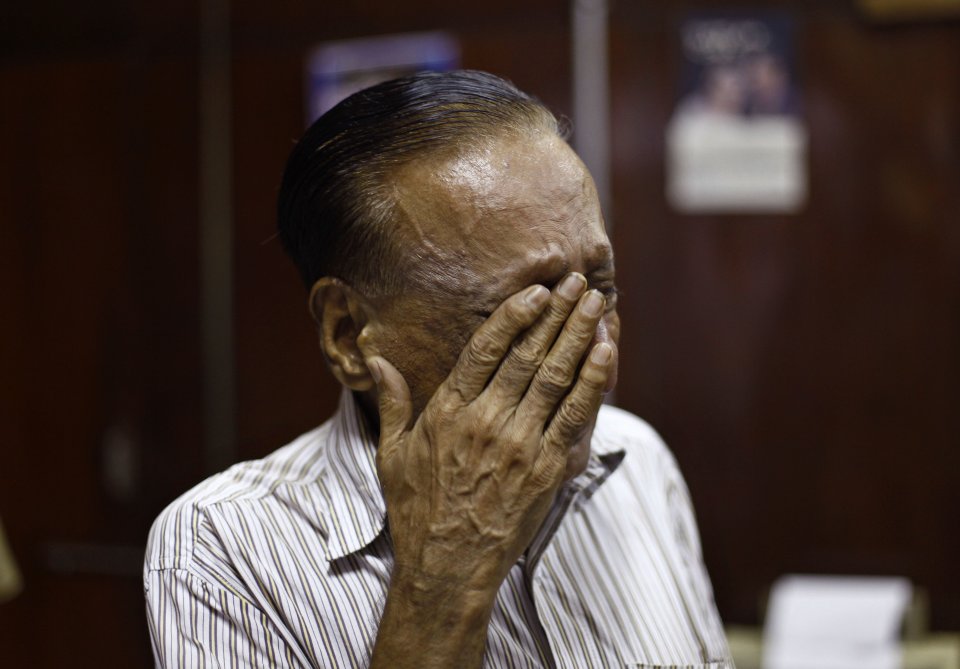 Indian man Mahinder, who claims to have made a living working as a telegram agent for the past six decades wipes his tears on the last day of the 163-year-old telegram service at the central telegraph office in Mumbai, India, Sunday, July 14, 2013. Sunday night, the state-run telecommunications company will send its final telegram, closing down a service that fast became a relic in an age of email, reliable land lines and ubiquitous cell phones. (AP Photo/Rafiq Maqbool)