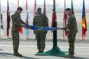 International Security Assistance Force Joint Command (IJC), Lieutenant General Joseph Anderson, left, folds the flag of IJC during a flag-lowering ceremony in Kabul, Afghanistan, Monday, Dec. 8, 2014. The U.S. and NATO ceremonially ended their combat mission in Afghanistan on Monday, 13 years after the Sept. 11 terror attacks sparked their invasion of the country to topple the Taliban-led government. From Jan. 1, the coalition will maintain a force of 13,000 troops in Afghanistan, down from a peak around 140,000 in 2011. There are around 15,000 troops now in the country.(AP Photo/Massoud Hossaini)