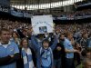 A Manchester City holds up a banner praising manager Roberto Mancini before the team's English Premier League soccer match against Queens Park Rangers at The Etihad Stadium, Manchester, England, Sunday May 13, 2012. Manchester City won the game and in so doing the English Premier League for the first time in 44 years. (AP Photo/Jon Super)