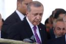 Turkish President Erdogan looks on after arriving at Esenboga Airport in Ankara