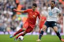 Liverpool's striker Luis Suarez (L) takes on Tottenham Hotspur's midfielder Nacer Chadli during an English Premier League football match at Anfield in Liverpool, northwest England on March 30, 2014