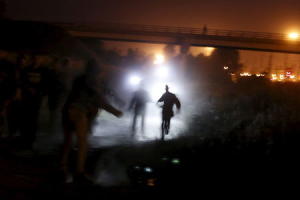 Migrants are illuminated by police torches as they&nbsp;&hellip;