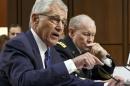 In this Sept. 16, 2014, photo, Defense Secretary Chuck Hagel, left, and Army Gen. Martin Dempsey, chairman of the Joint Chiefs of Staff, appear before the Senate Armed Services Committee in Washington. The White House and the Pentagon are grappling with how to explain what American military forces are doing and could do in Iraq as they battle the Islamic State militants. Speaking at U.S. Central Command on Wednesday, President Barack Obama reiterated his pledge to keep American troops out of combat missions. But hours later, Vice President Joe Biden appeared to be less certain about ground troops. "We'll determine that based on how the effort goes," Biden told reporters in Iowa. Biden's remarks echoed comments a day earlier from Army Gen. Martin Dempsey, the Joint Chiefs chairman, who said he may, if necessary, recommend to the president that U.S. ground forces accompany Iraqi troops on attacks against Islamic State targets, particularly in certain complex missions or if there were threats to the U.S. (AP Photo/J. Scott Applewhite)