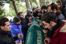 People pray next to the coffin of Mohamed Elhot, one of the victims of the Reina night club attack, during his funeral ceremony on January 3, 2017 in Istanbul