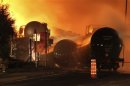 First responders fight burning trains after a train derailment and explosion in Lac-Megantic, Quebec