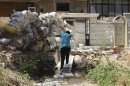 A Free Syrian Army fighter runs past sandbags piled for protection against snipers loyal to Syria's President Assad in the Seif El Dawla neighbourhood in Aleppo